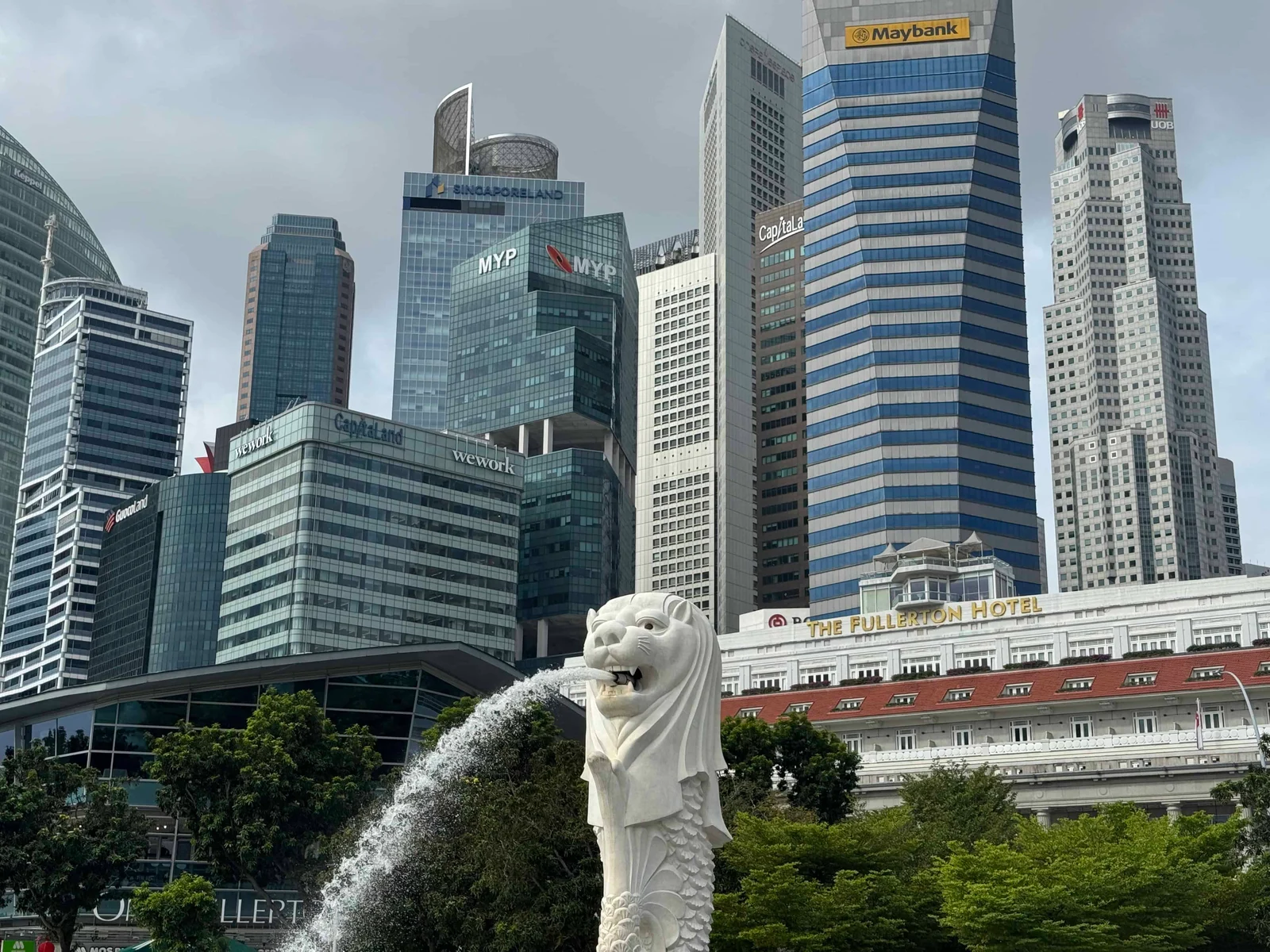 Merlion statue with city skyline