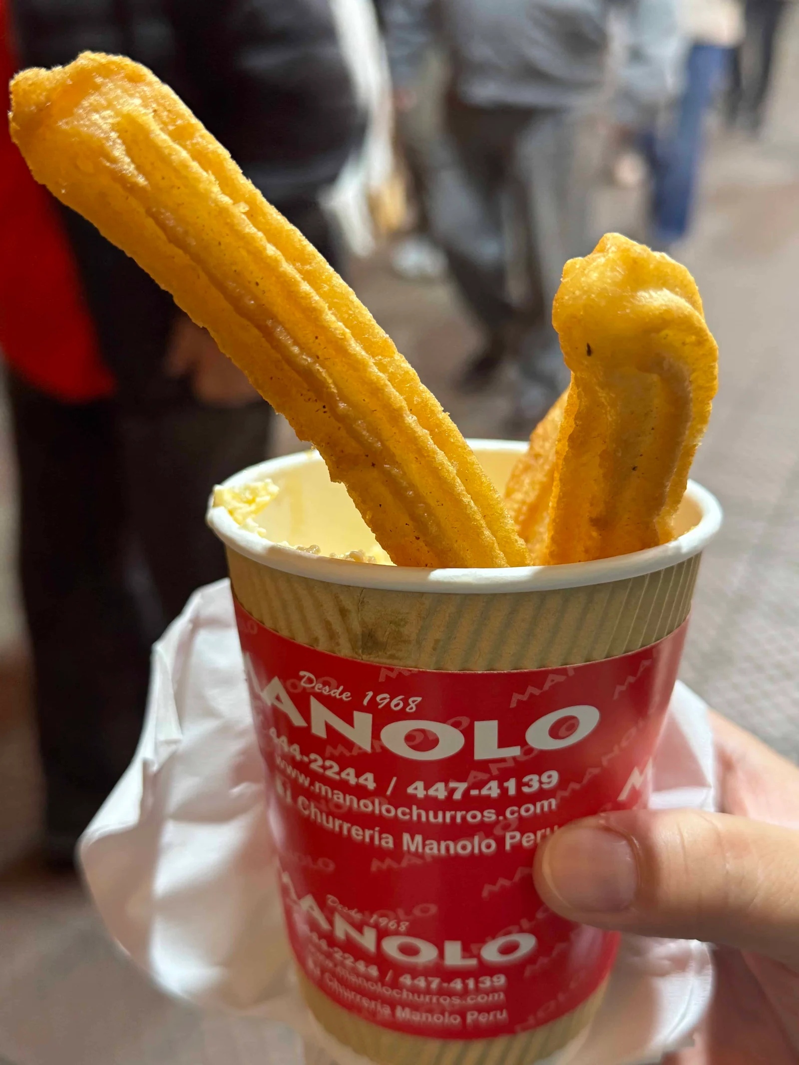 Two churros in a cup