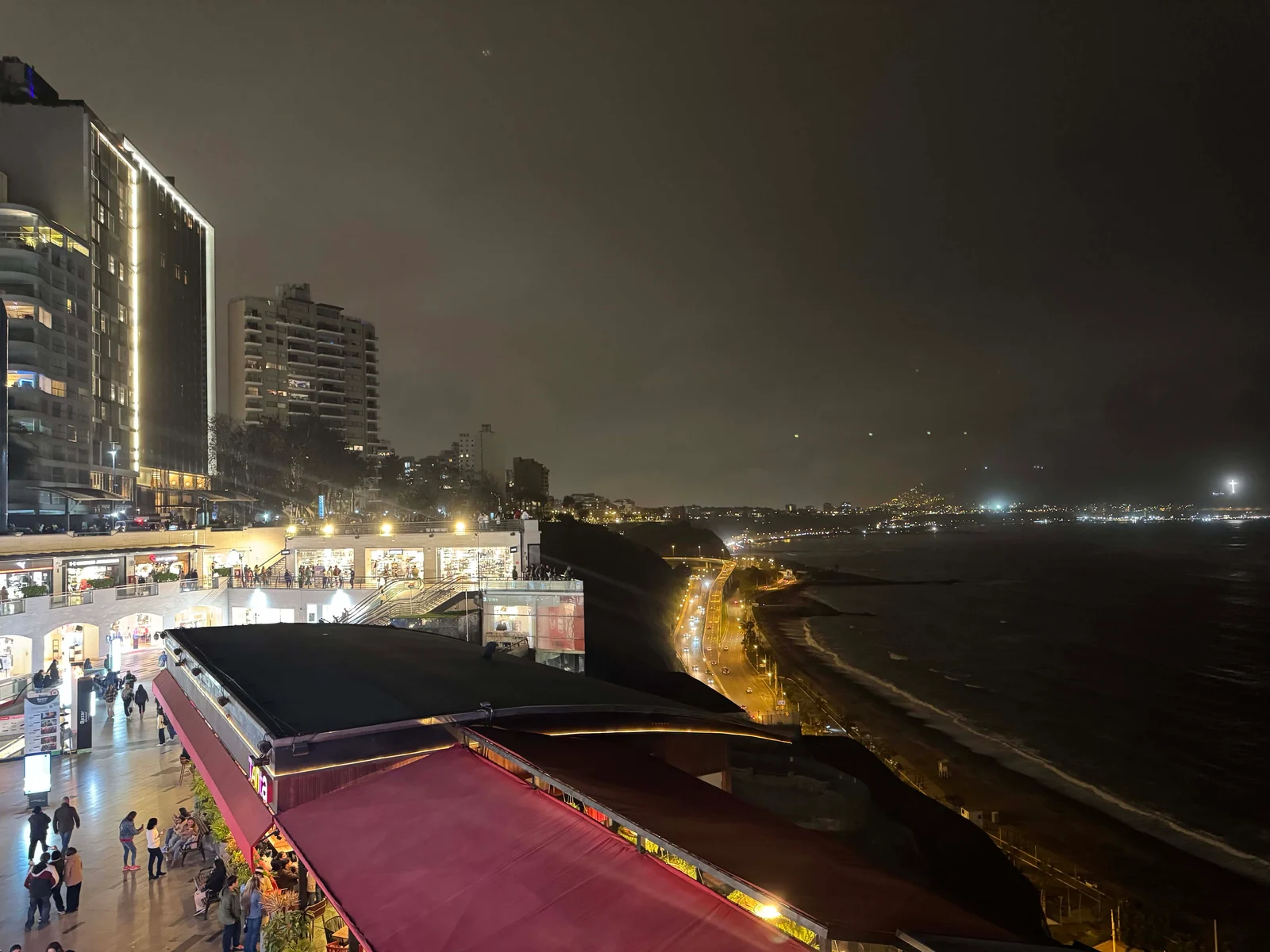 Nighttime cityscape with ocean view