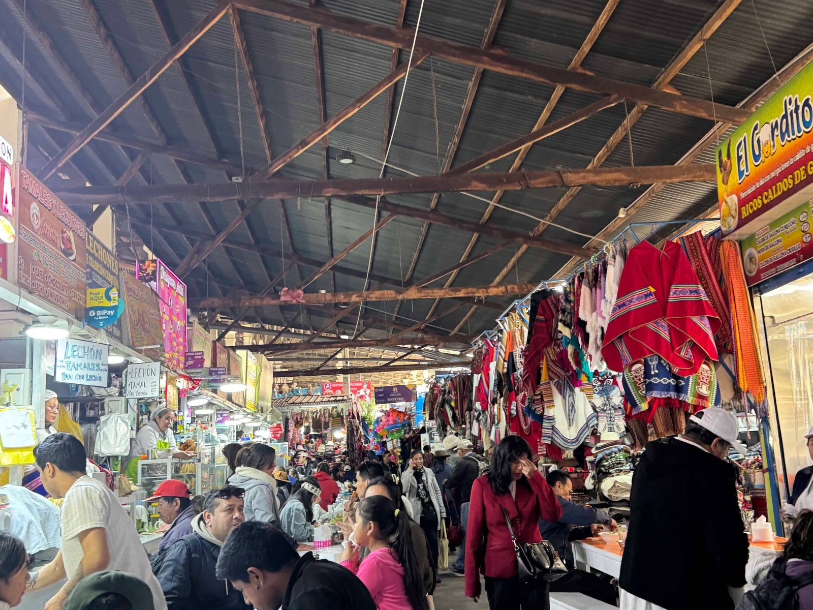 Busy indoor market with clothing