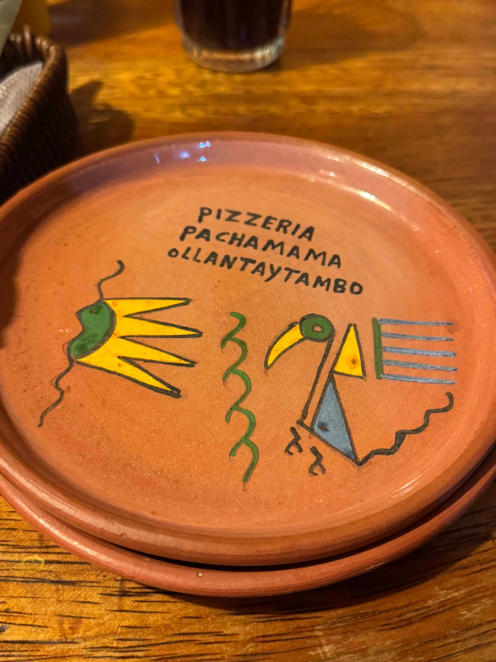 Terracotta plate with colourful bird design