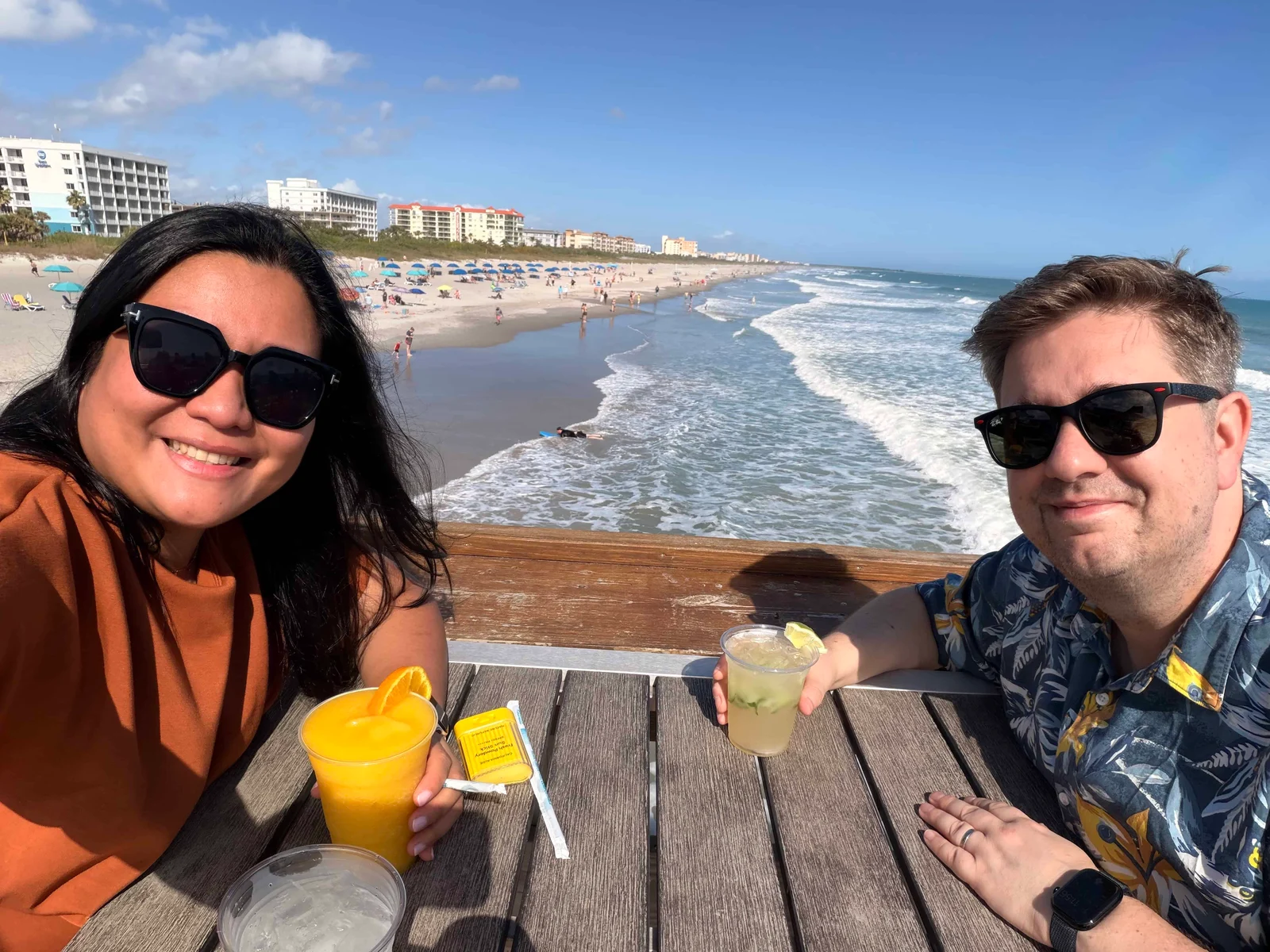 Two people smiling with drinks