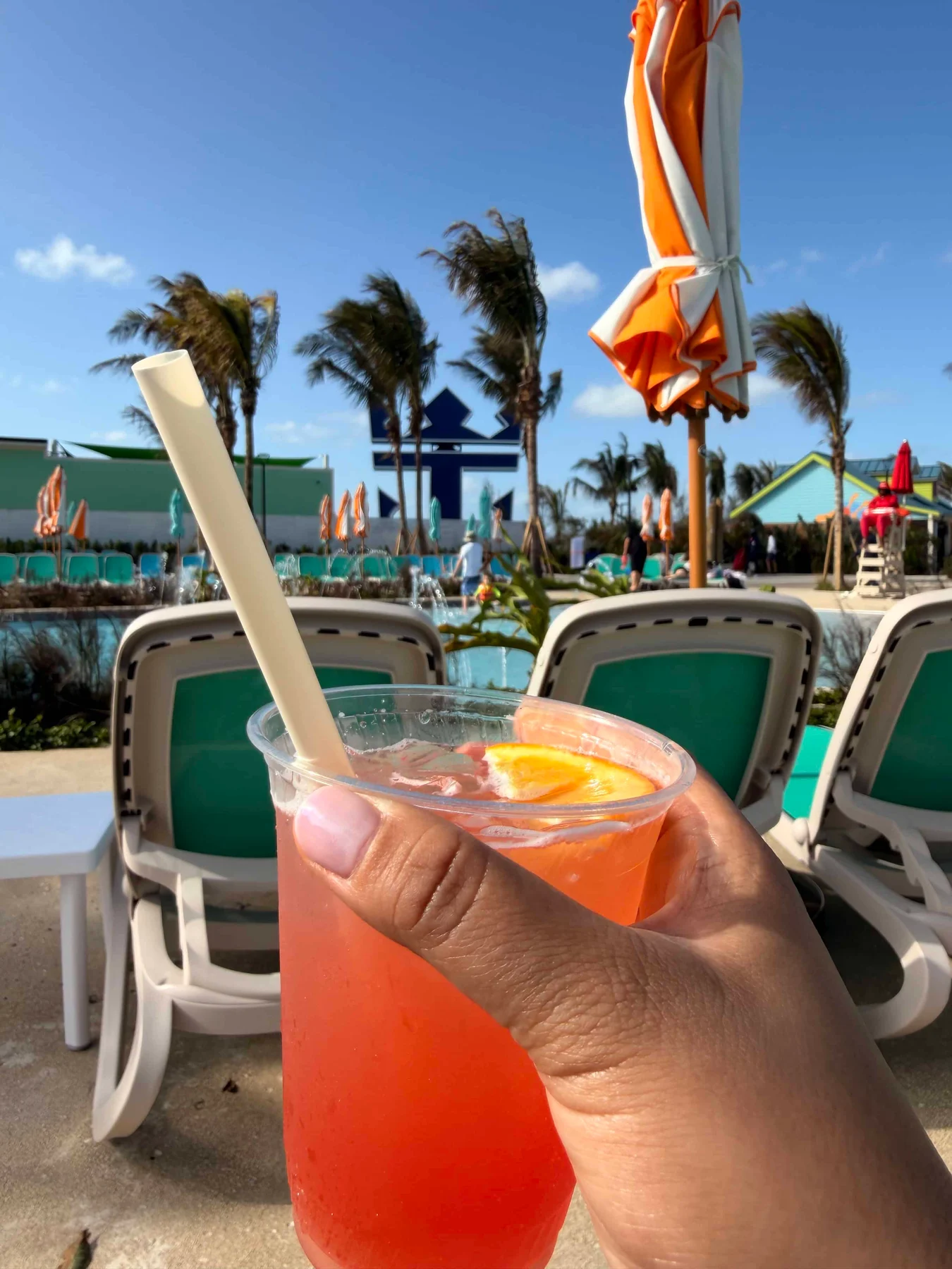 Two cocktails by poolside chairs
