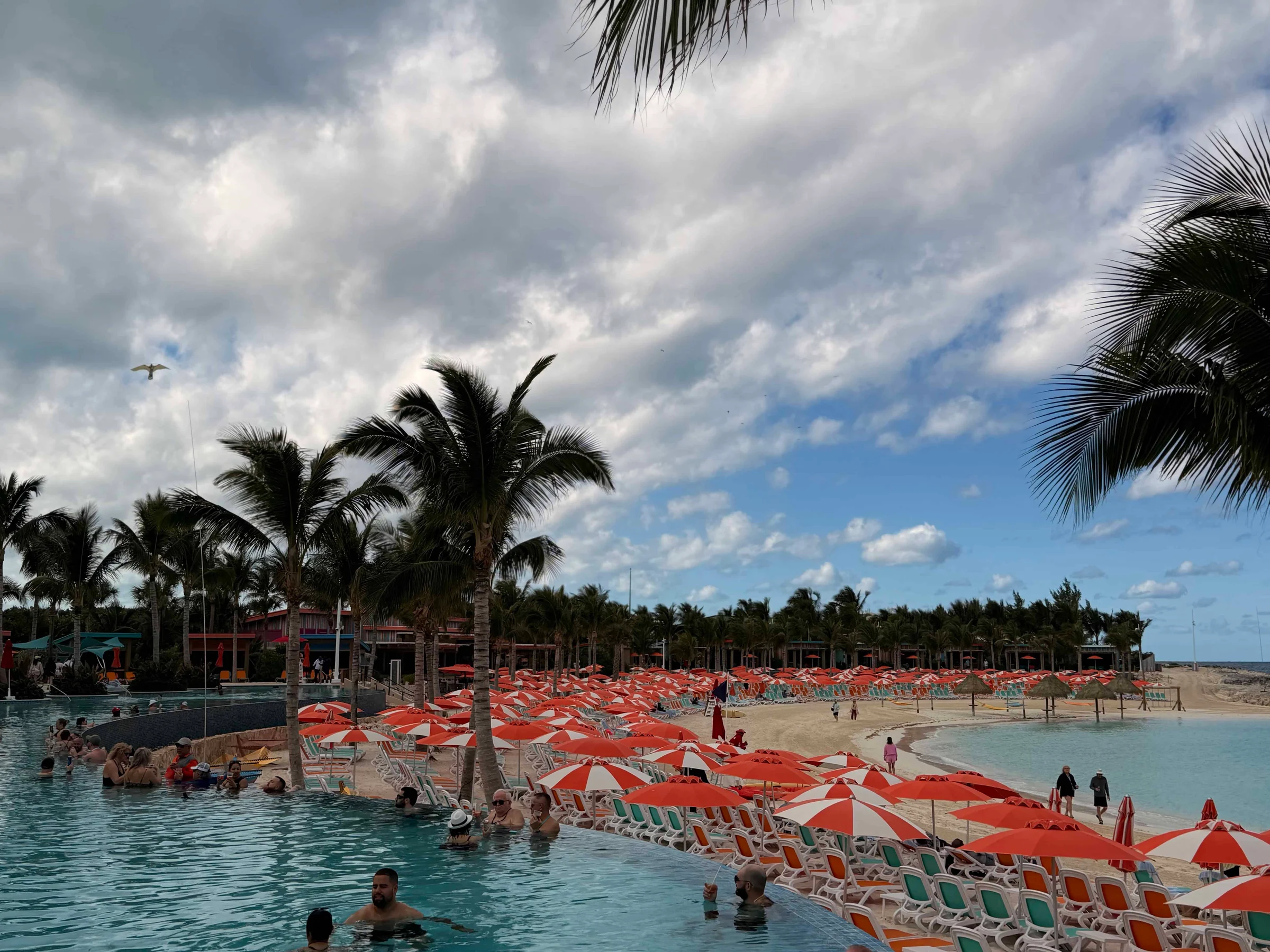 Beachside pool with orange umbrellas