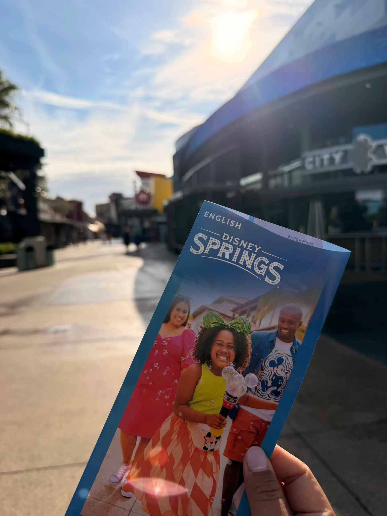 Disney Springs brochure held outdoors