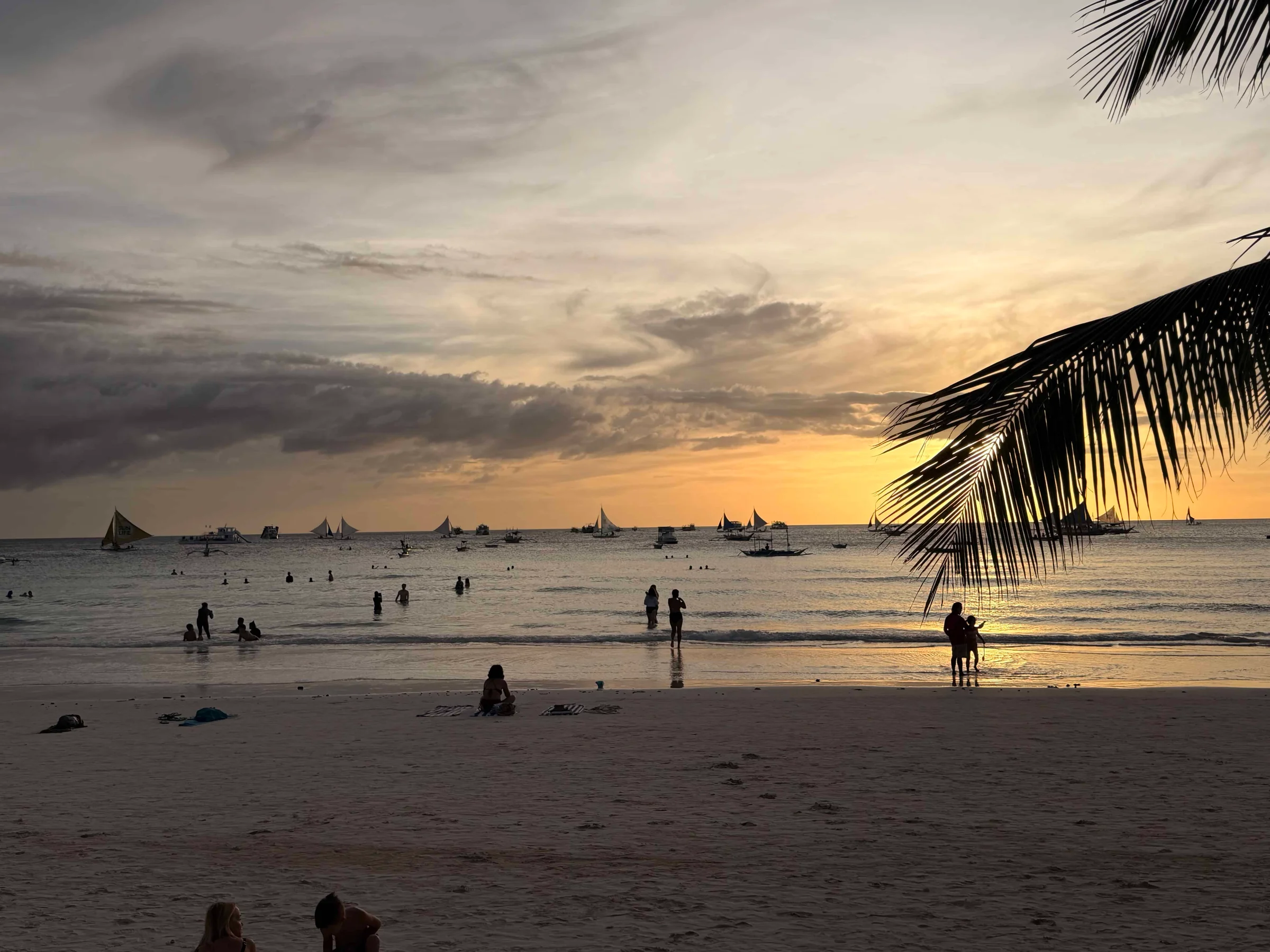 People on beach at sunset
