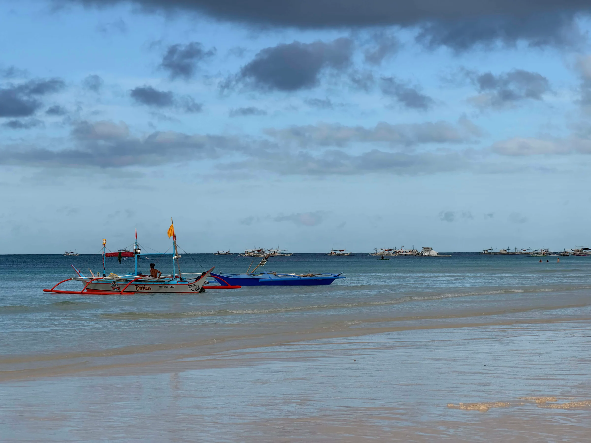 Colourful boats floating near shore