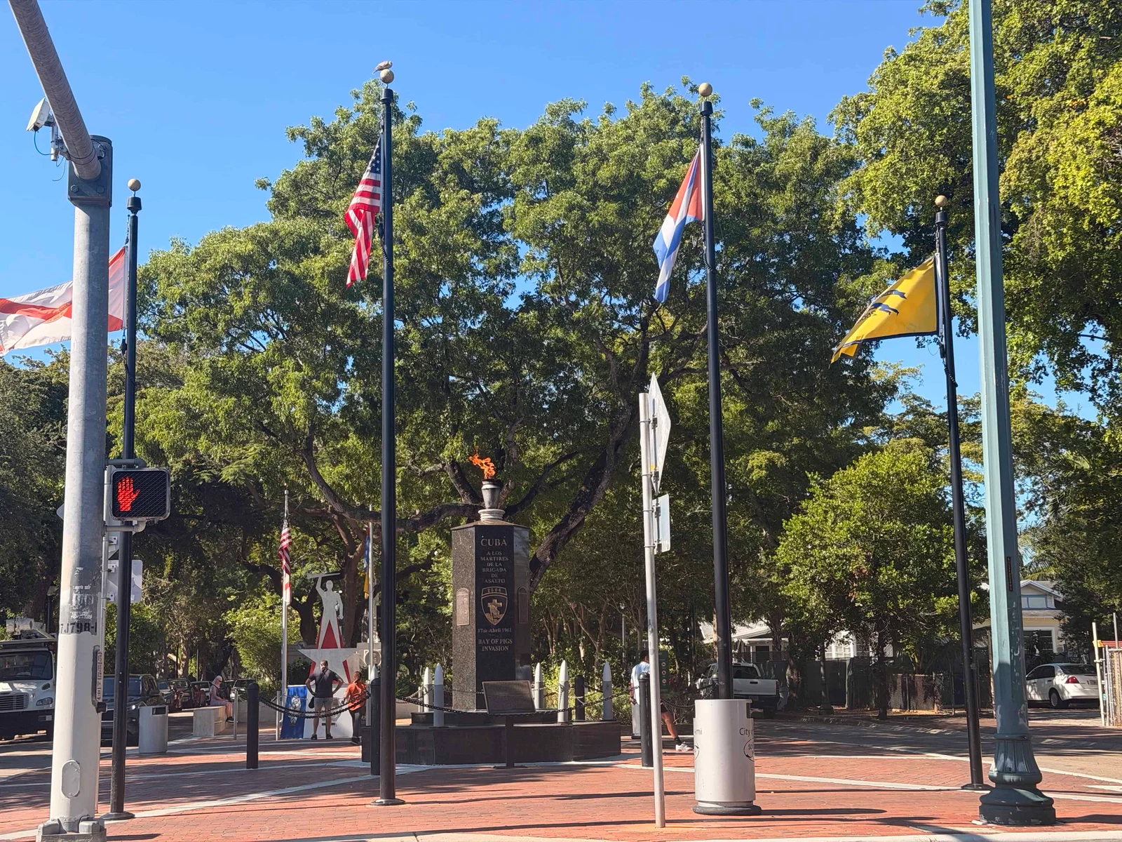 Cuban memorial with flags and torch