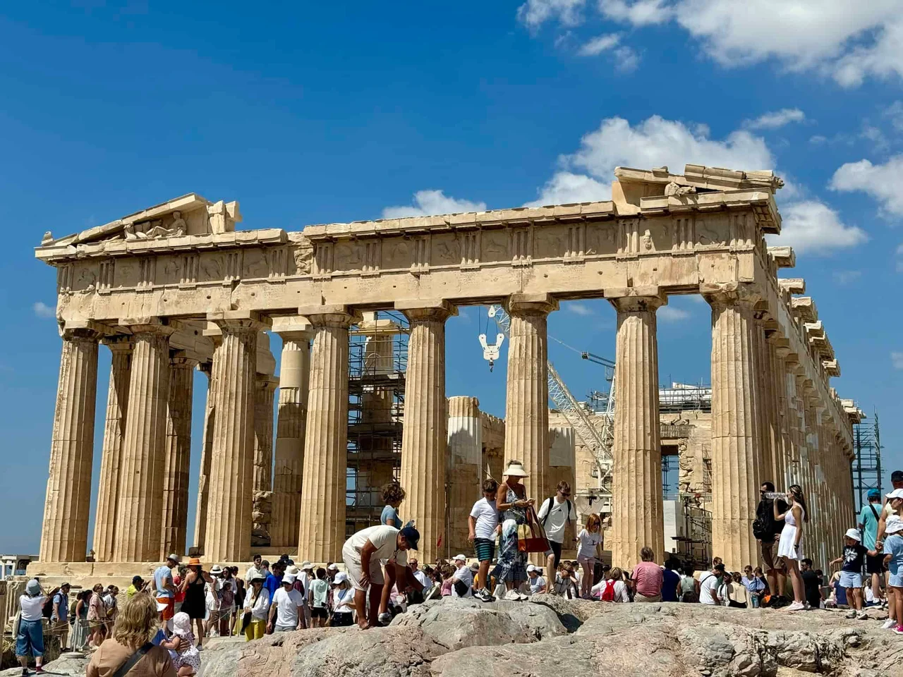 Crowds of visitors on the rock in front of the Parthenon