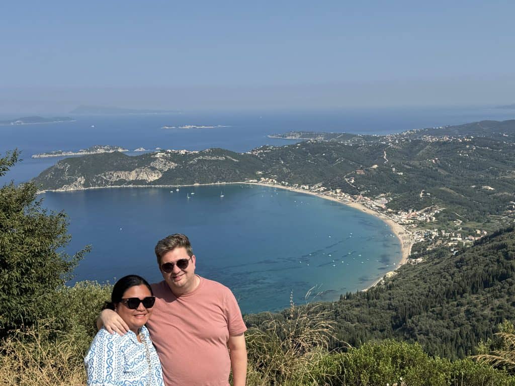 Two people posing near coastline