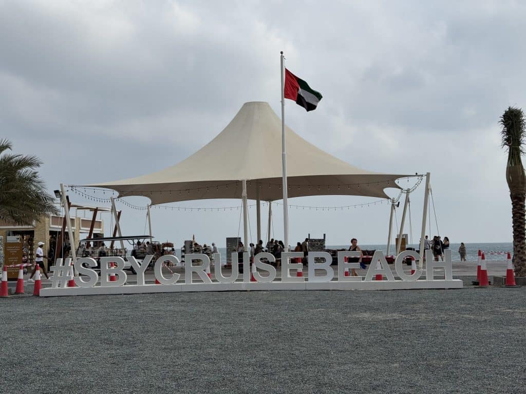 Beach sign with UAE flag