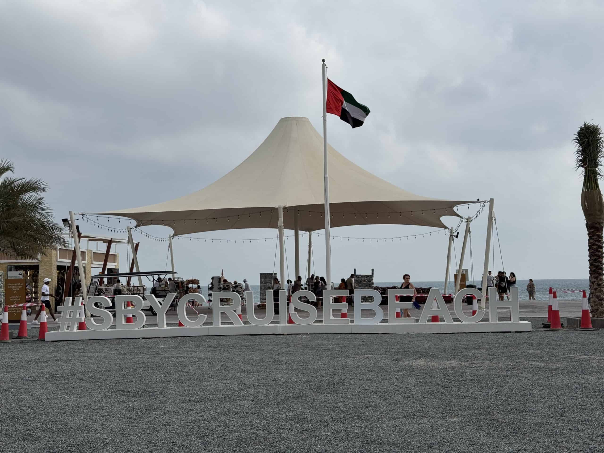 Beach sign with UAE flag