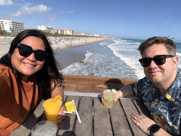 Two people smiling with drinks