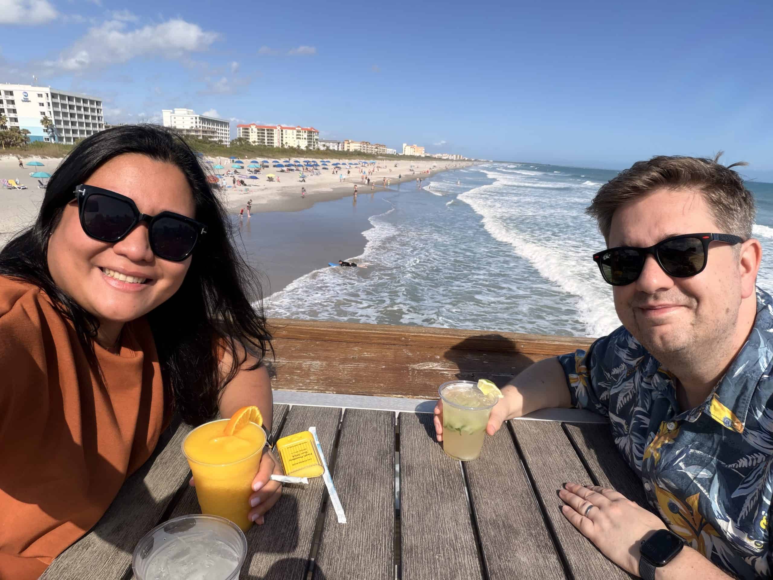 Two people smiling with drinks