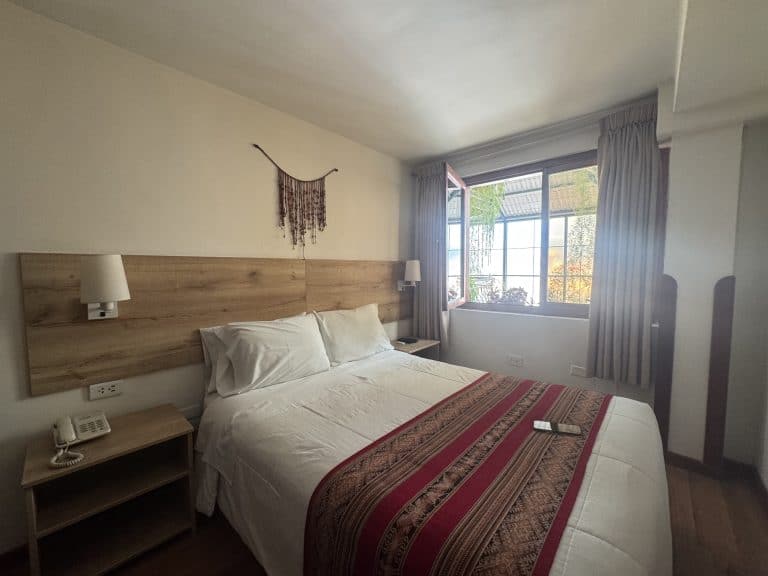 Bedroom with wooden headboard window