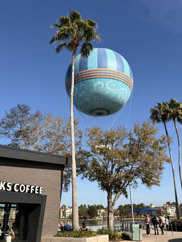 Blue hot air balloon over trees