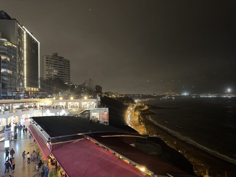 Nighttime cityscape with ocean view