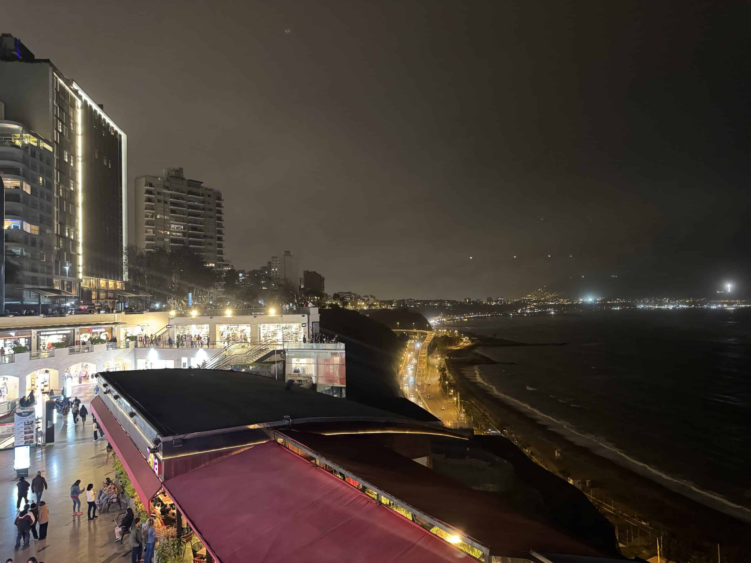 Nighttime cityscape with ocean view