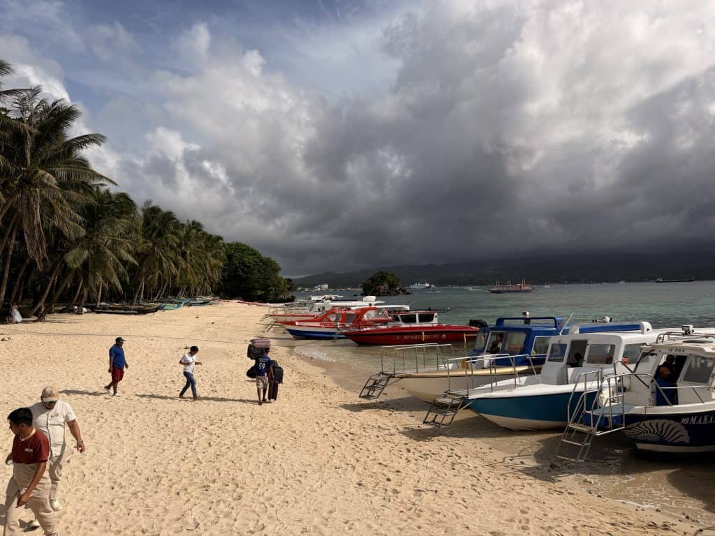 Boats docked on sandy beach