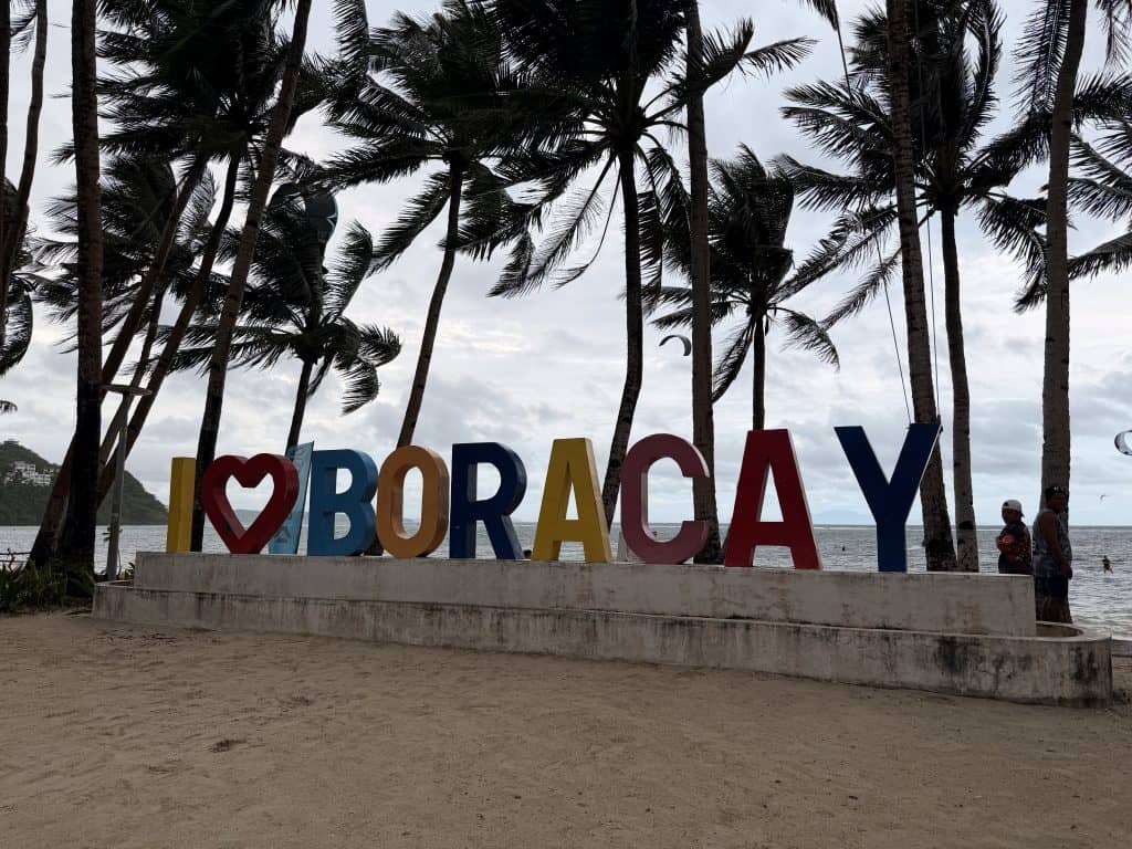 Colourful Boracay beach sign with palms