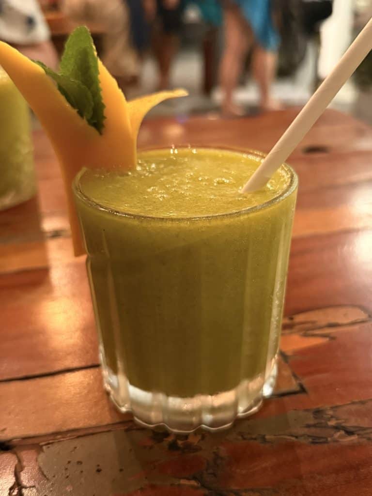 Green smoothie with mango garnish