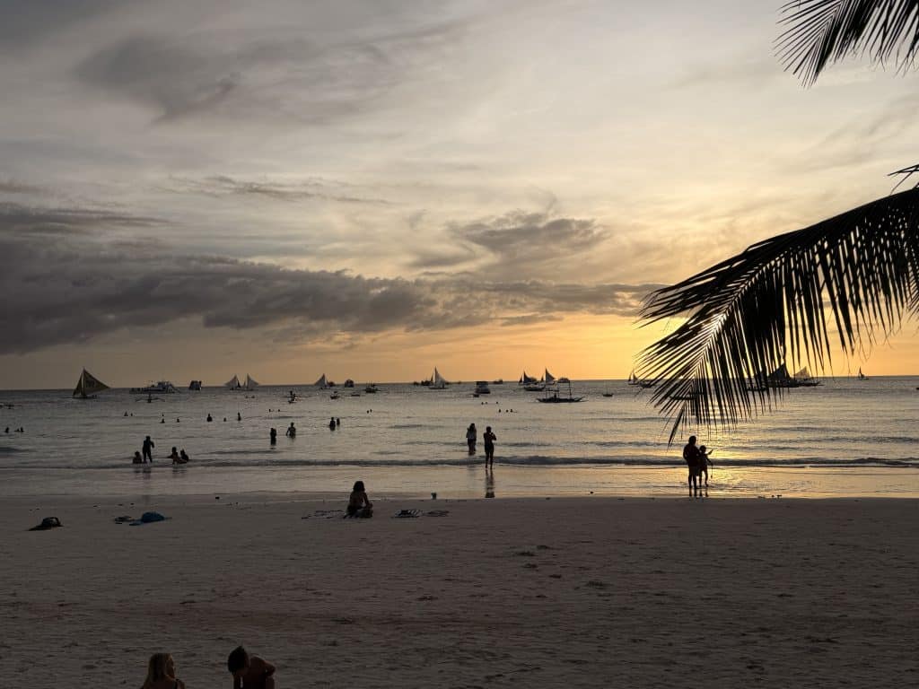 People on beach at sunset