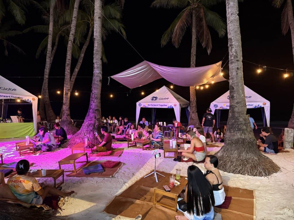 People relaxing at beach night event