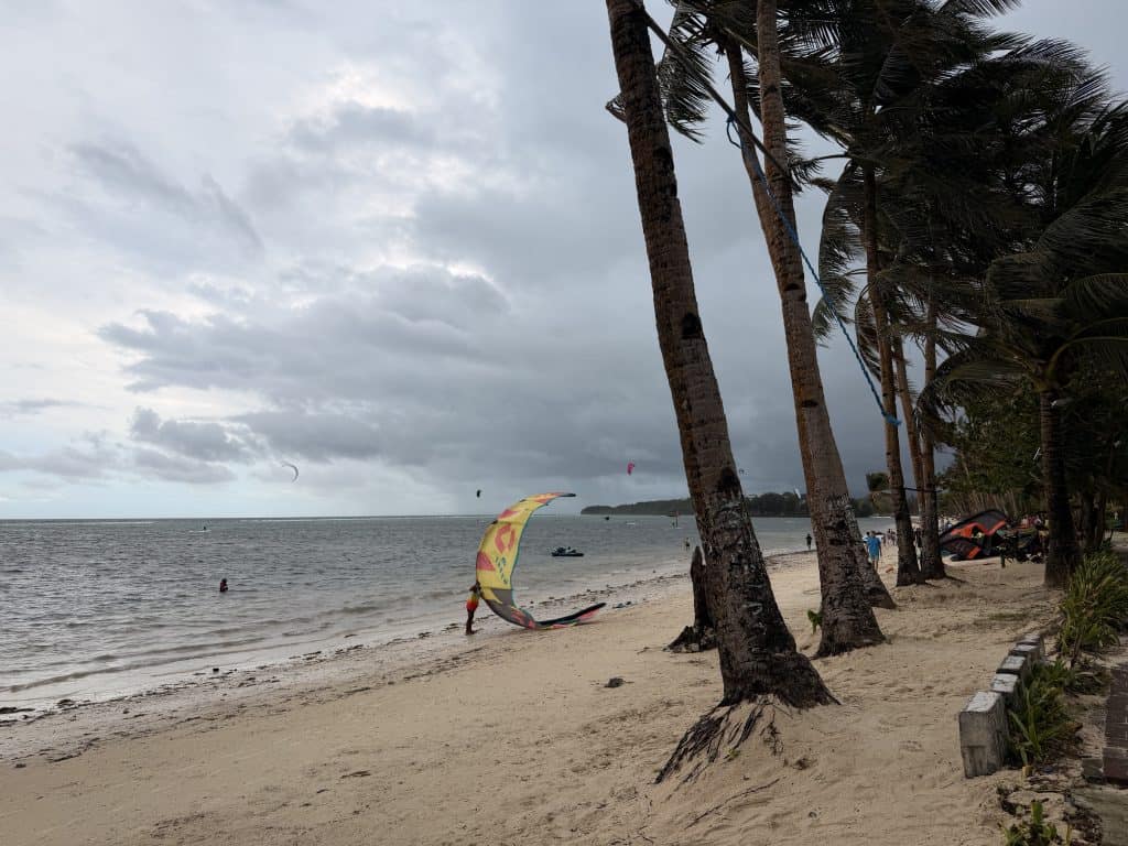 Person preparing kite on beach