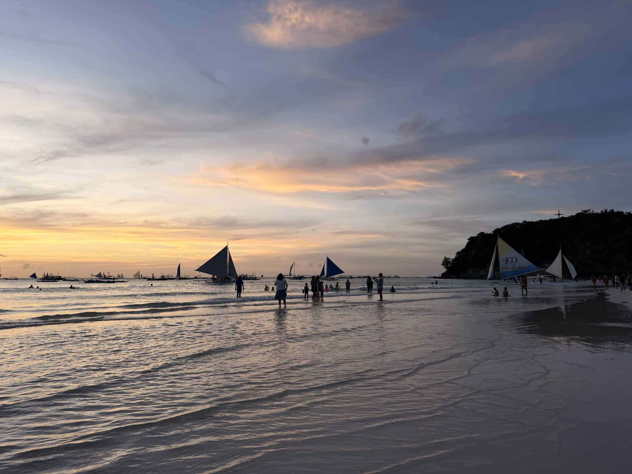 Sailboats and people on beach