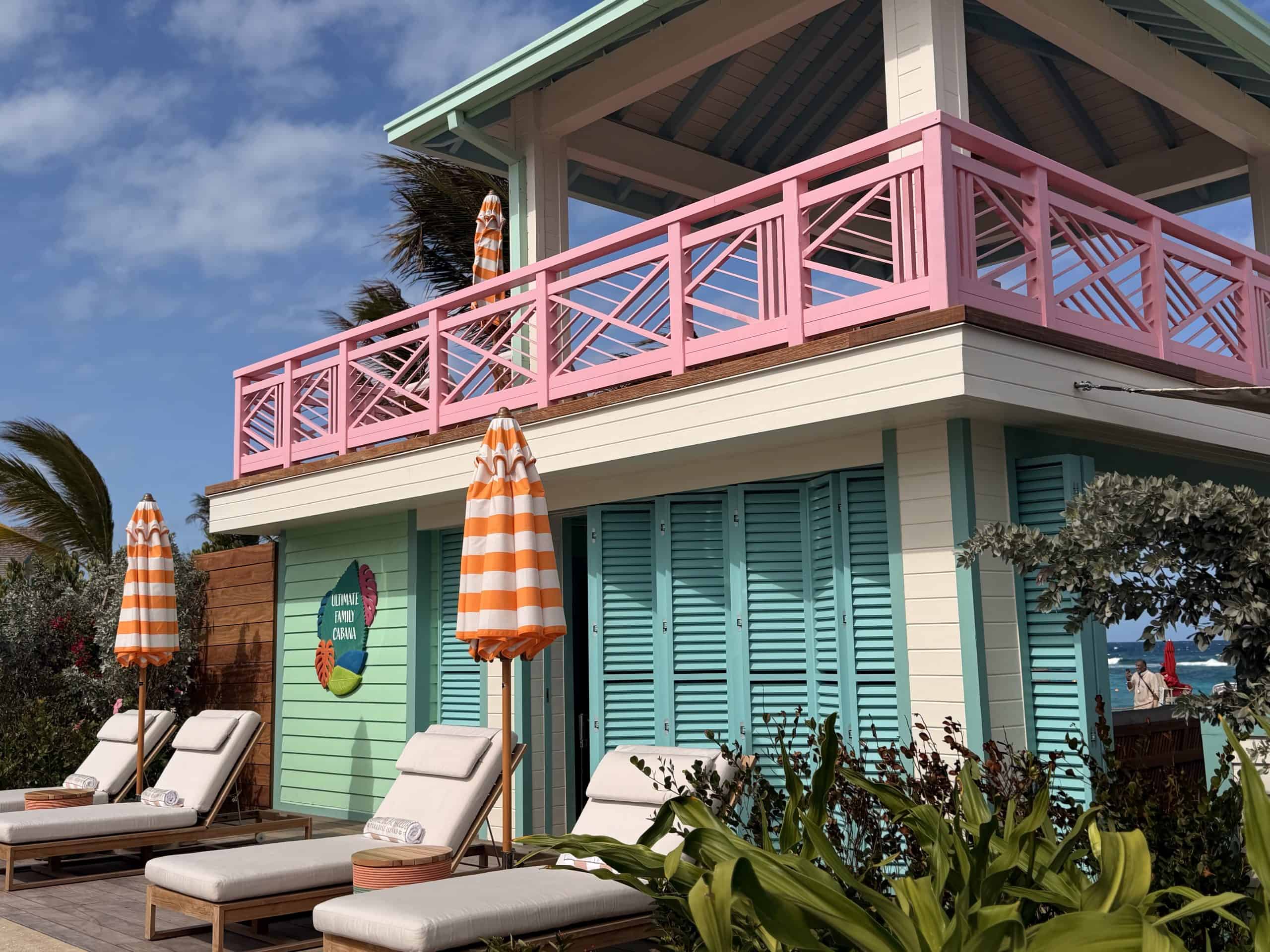 Turquoise beach house with pink railing