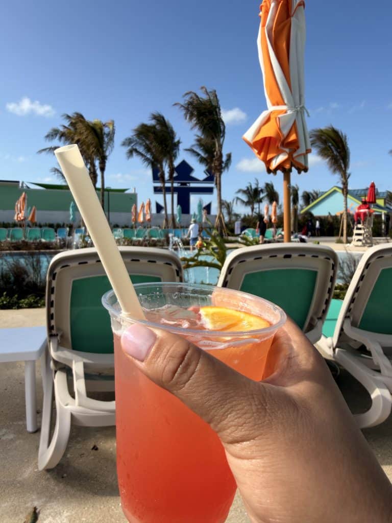 Two cocktails by poolside chairs