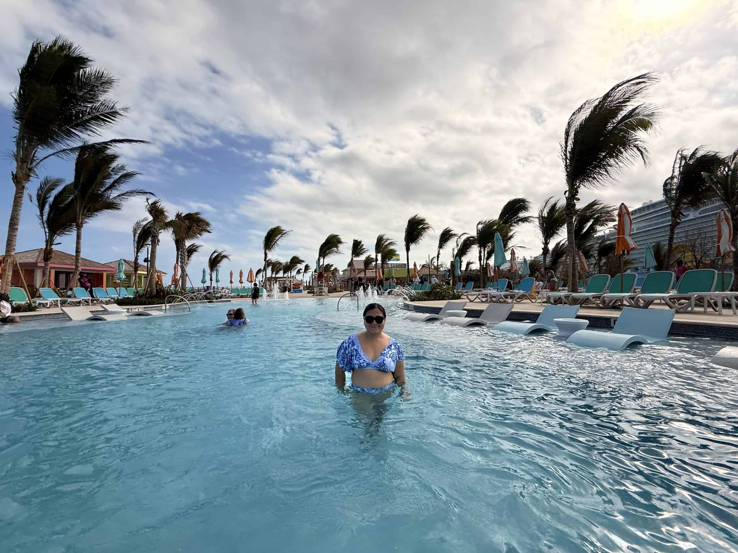 Woman in pool with palm trees