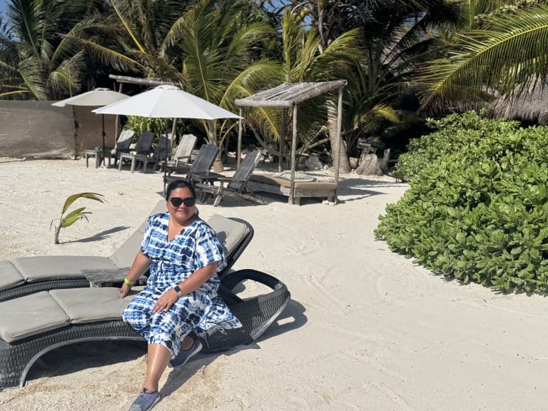 Woman sitting on beach lounge