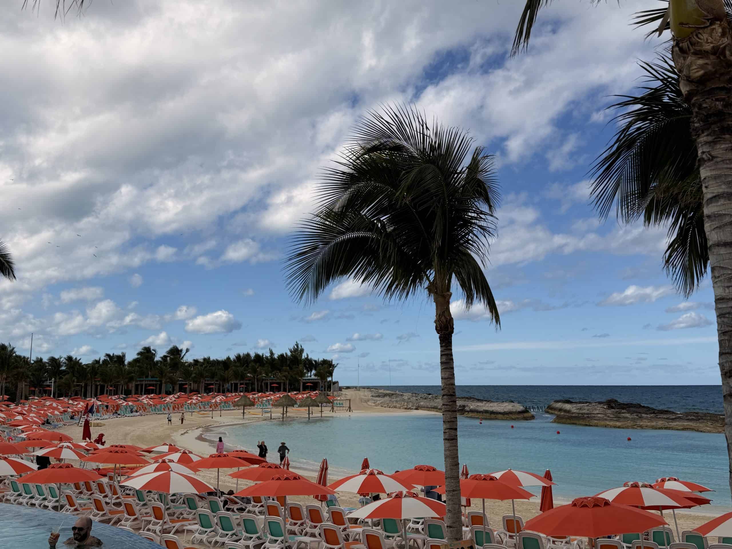 Beach with red umbrellas chairs