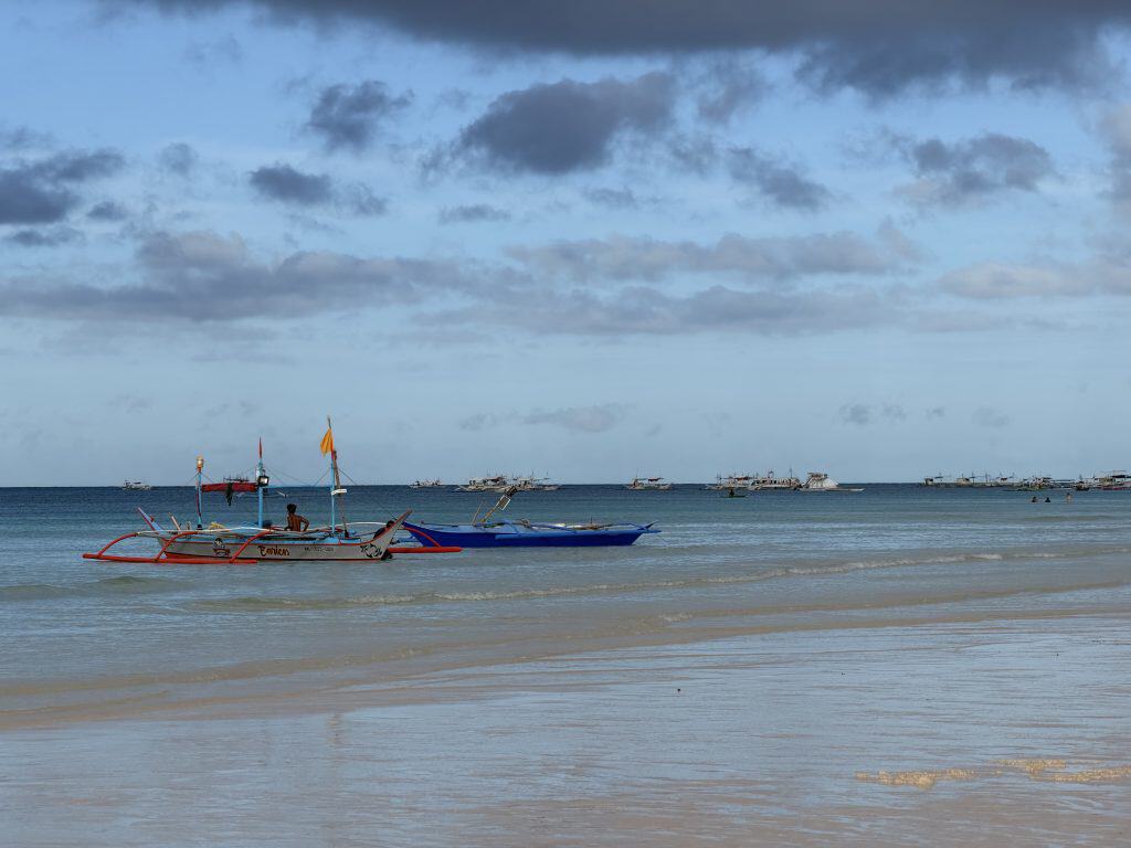 Colourful boats floating near shore