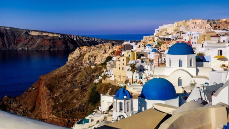 a scenic view of a town on the edge of a cliff
