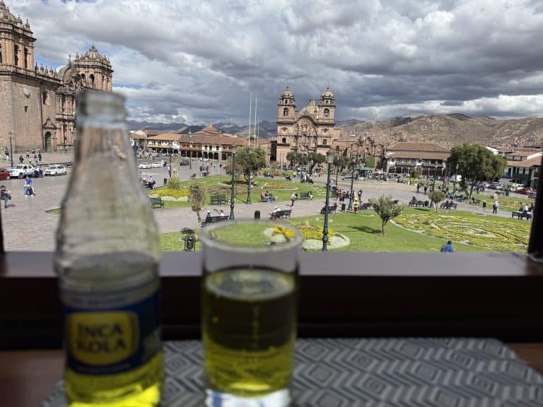 Two bottles on windowsill overlooking plaza