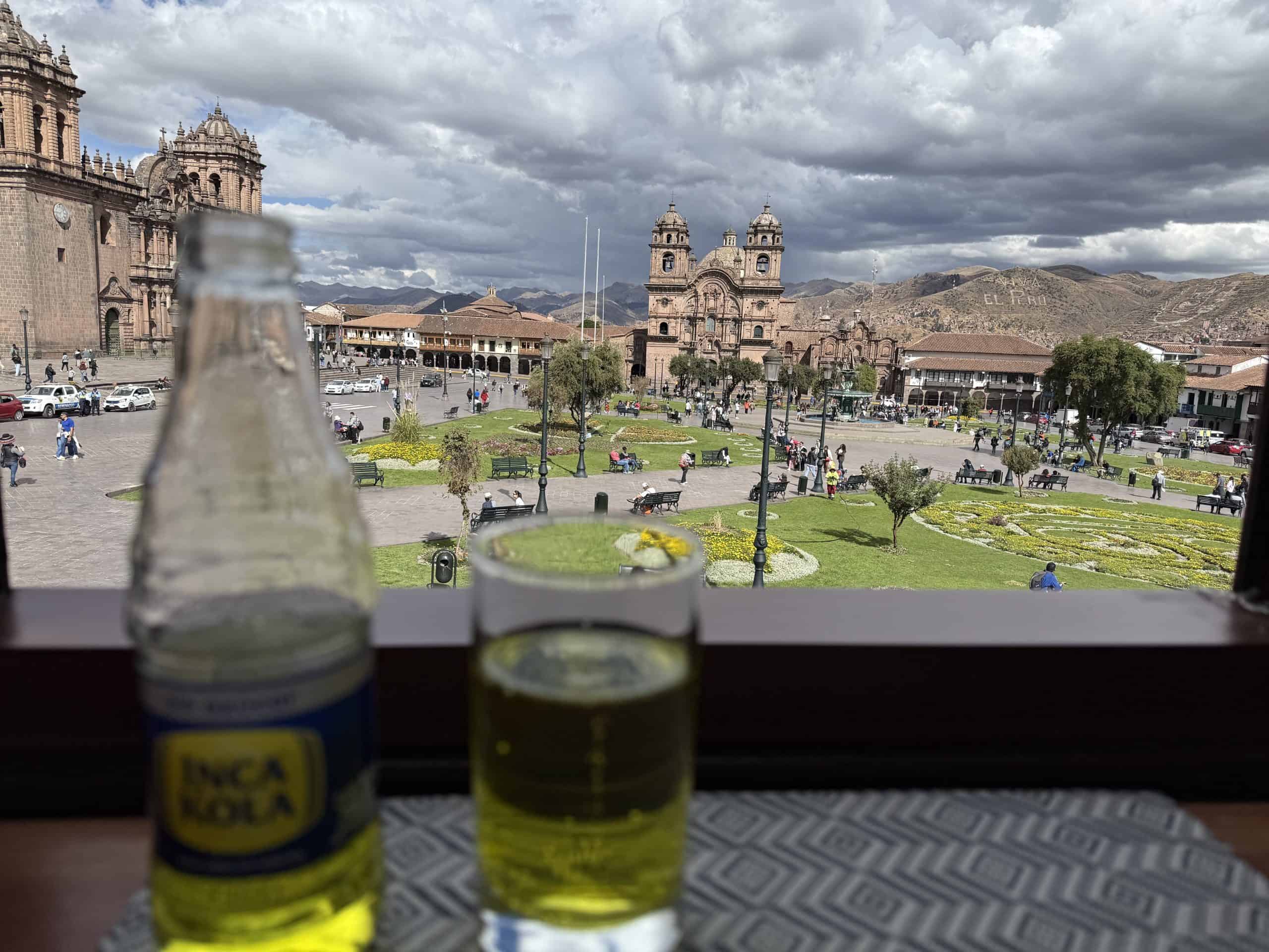 Two bottles on windowsill overlooking plaza